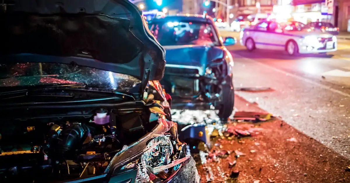 Car crash at night police car in the background