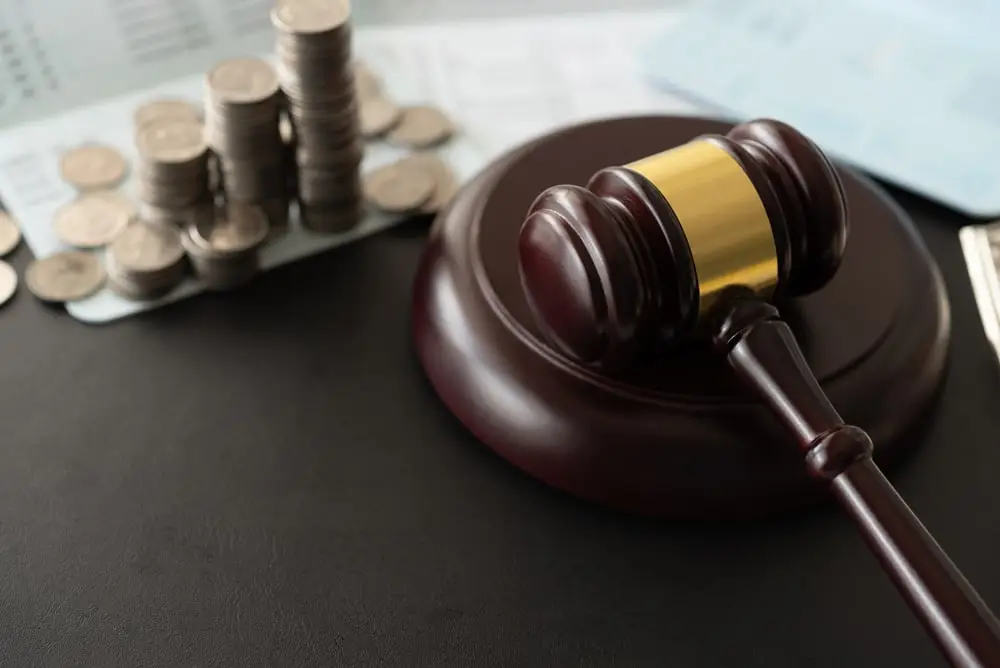 Gavel judge with money coin on book bank.