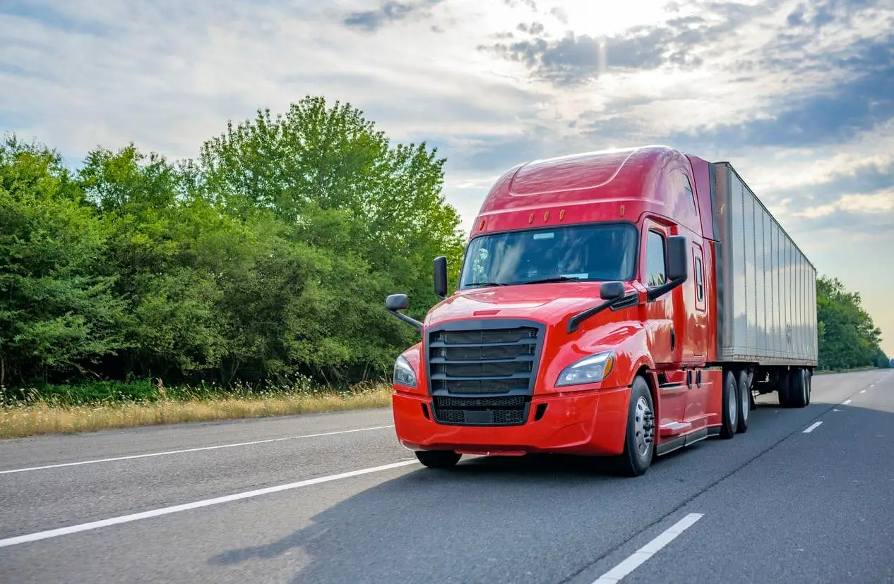 Red truck driving on highway