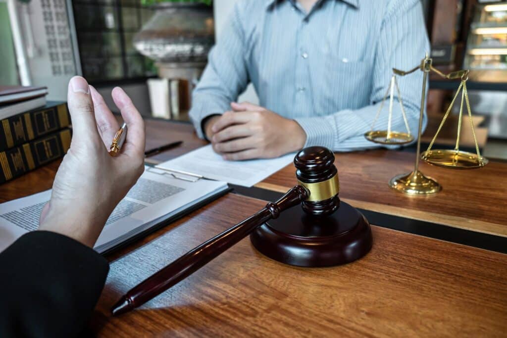Professional male lawyer or counselor discussing negotiation legal case with client