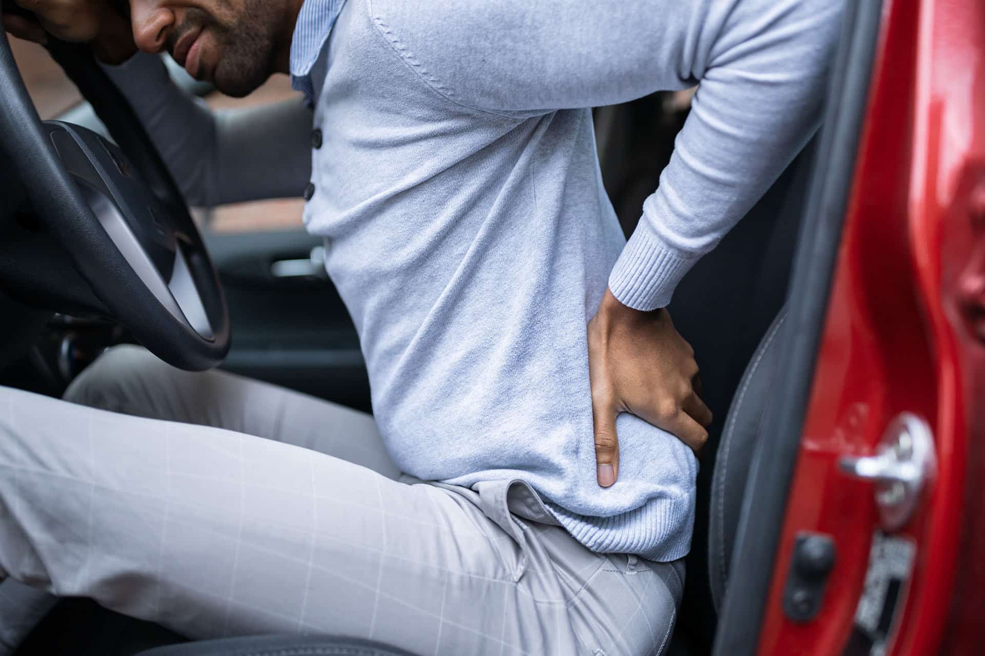 Driver standing having backpain after driving car