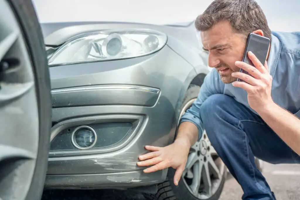 One man reporting car damage calling insurance service