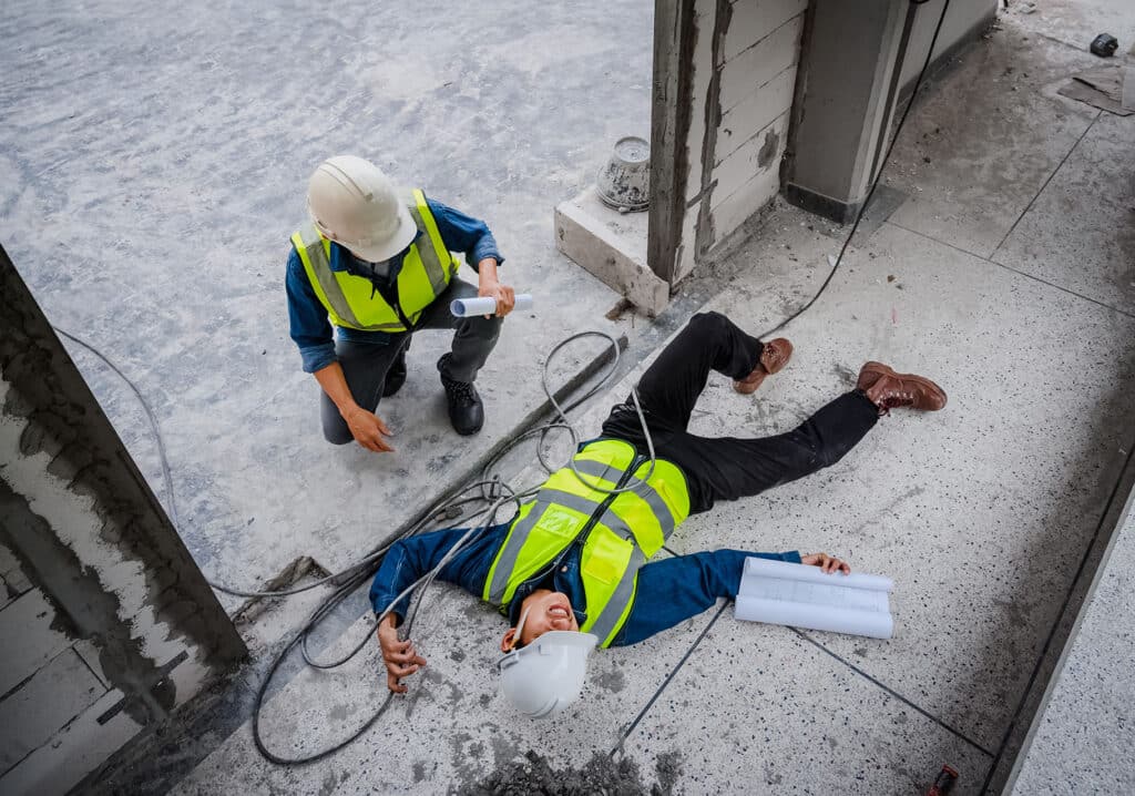 An asian engineer or electrician is electrocuted to the ground.