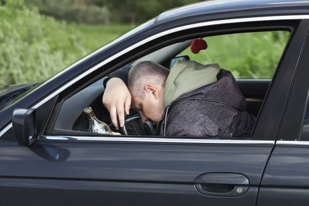 Drunk man asleep at the wheel