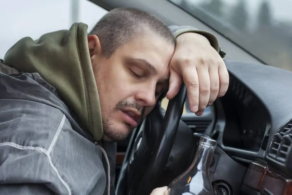 Drunk man lying on the steering wheel