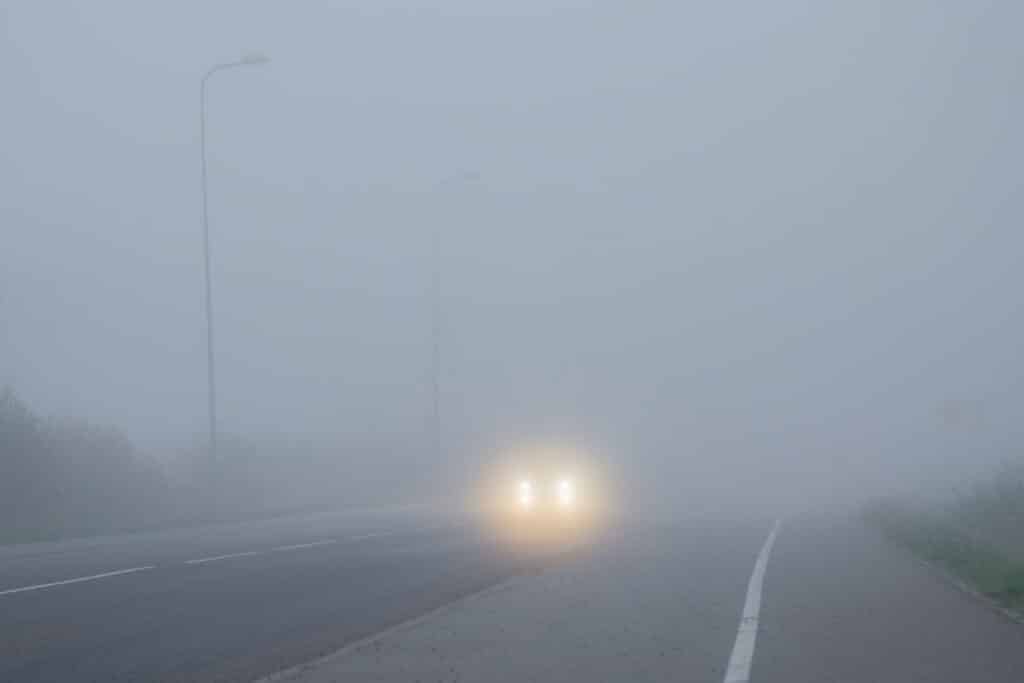Poor visibility in fog on road