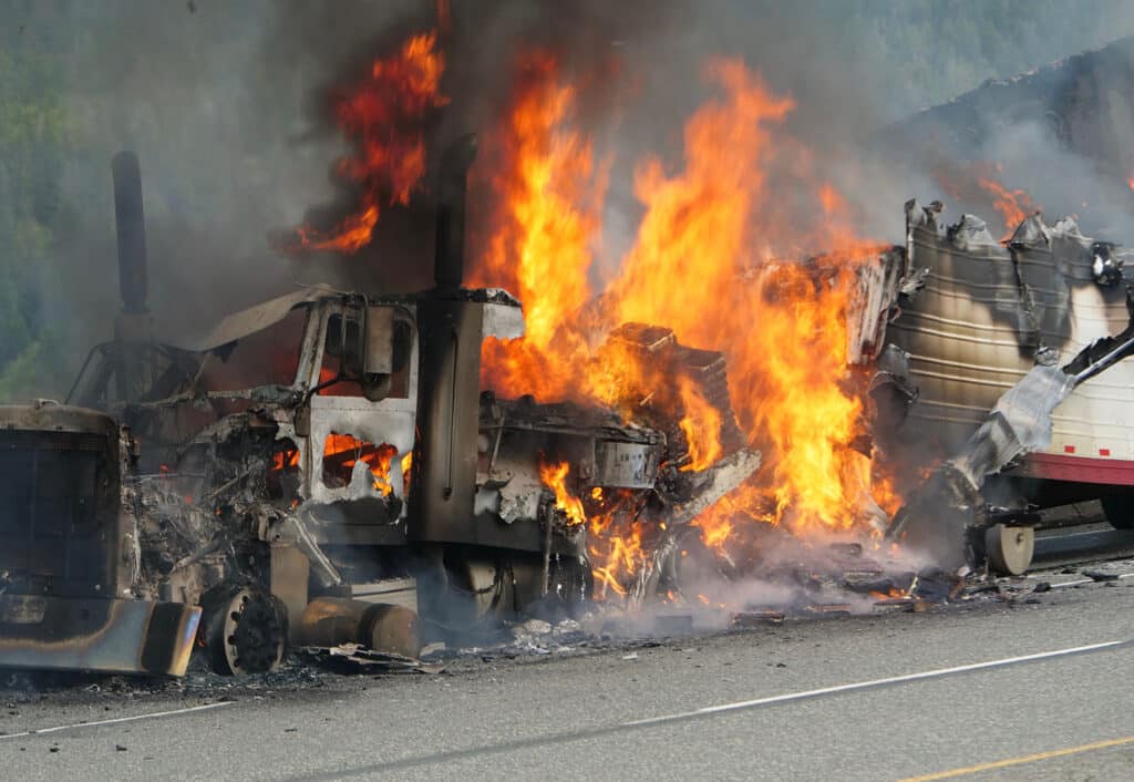 A semi truck burns out of control on the highway