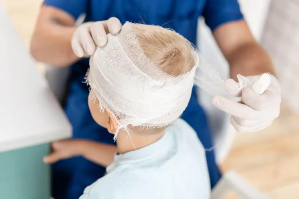 Doctor makes bandage on head patient, in the hospital.