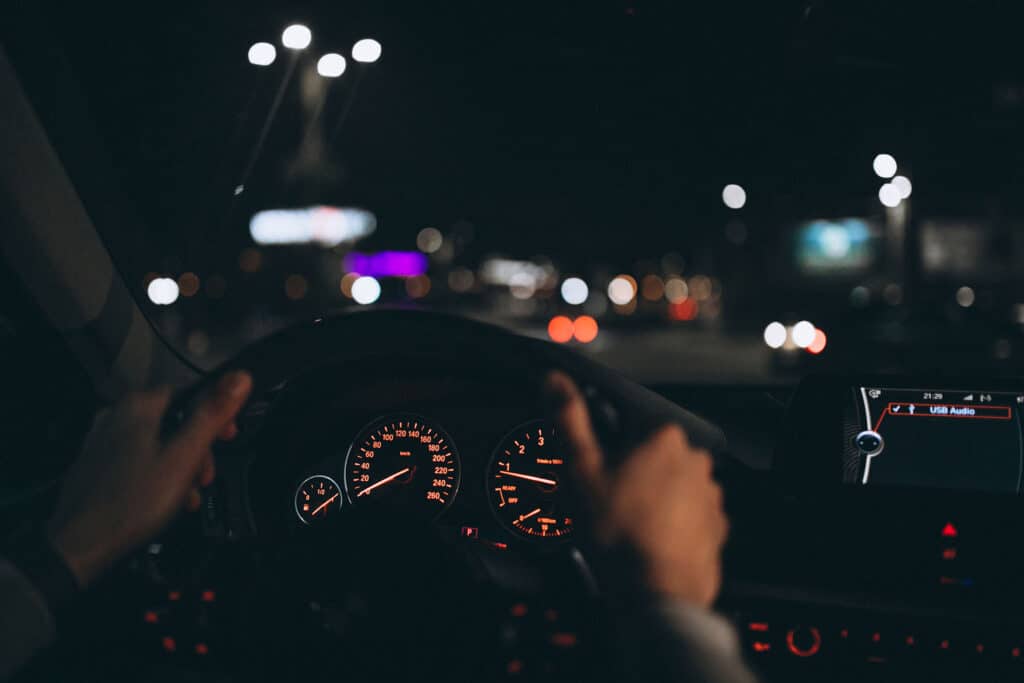 Young man driving his car at a night time