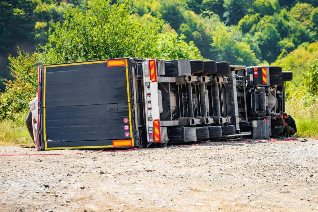 Large cargo truck turned over on road traffic accident at day