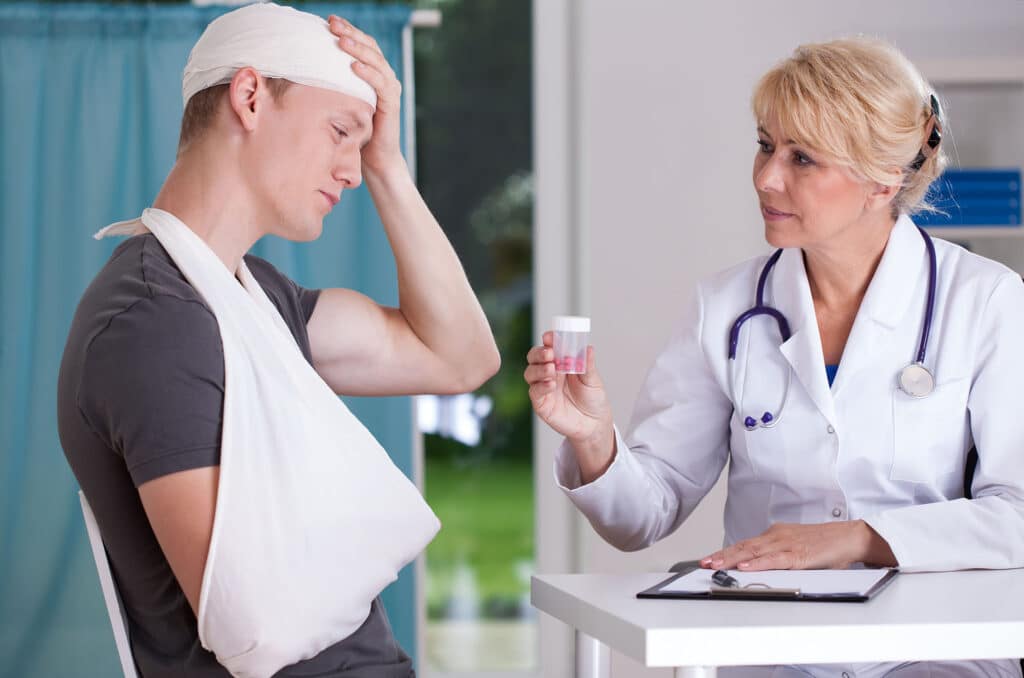 Physician giving to patient pills for headache