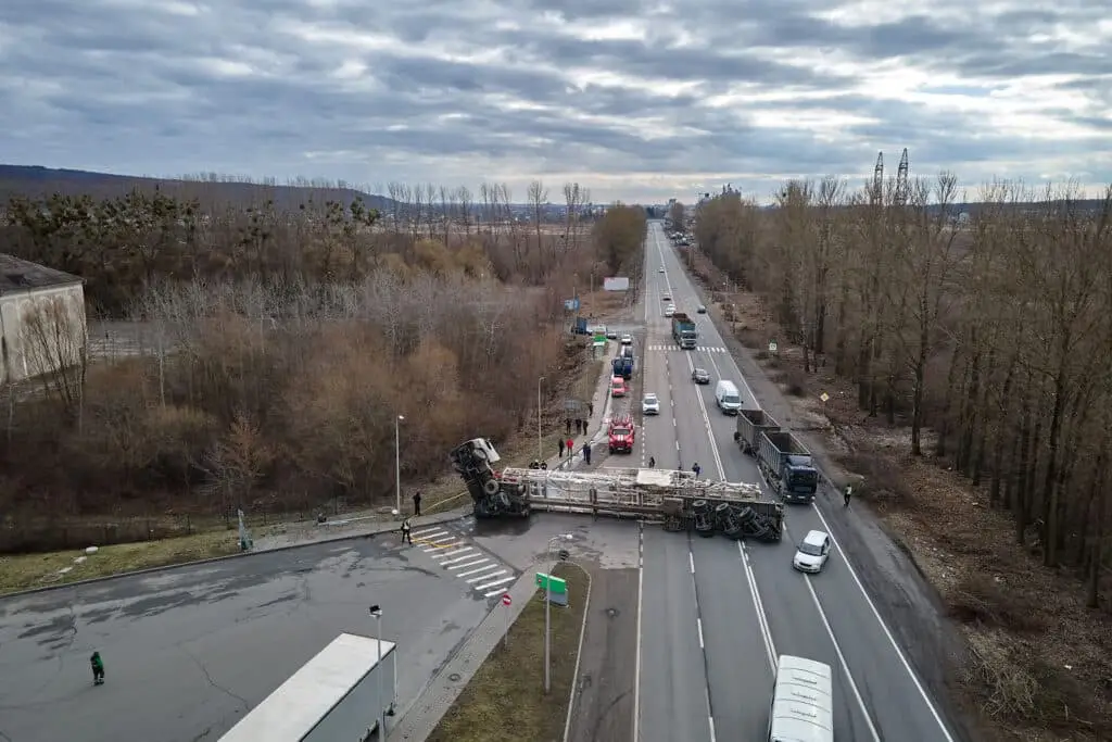 Aerial view of road accident with overturned truck blocking traffic