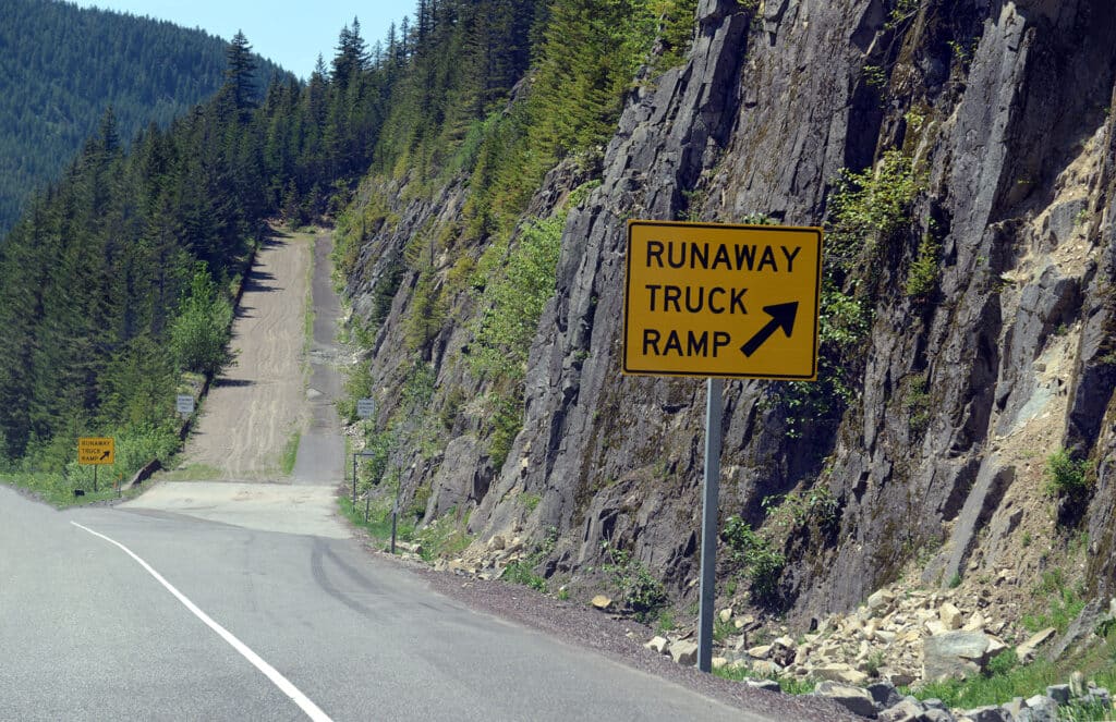 Road sign for runaway truck ramp in the forest on a mountain road