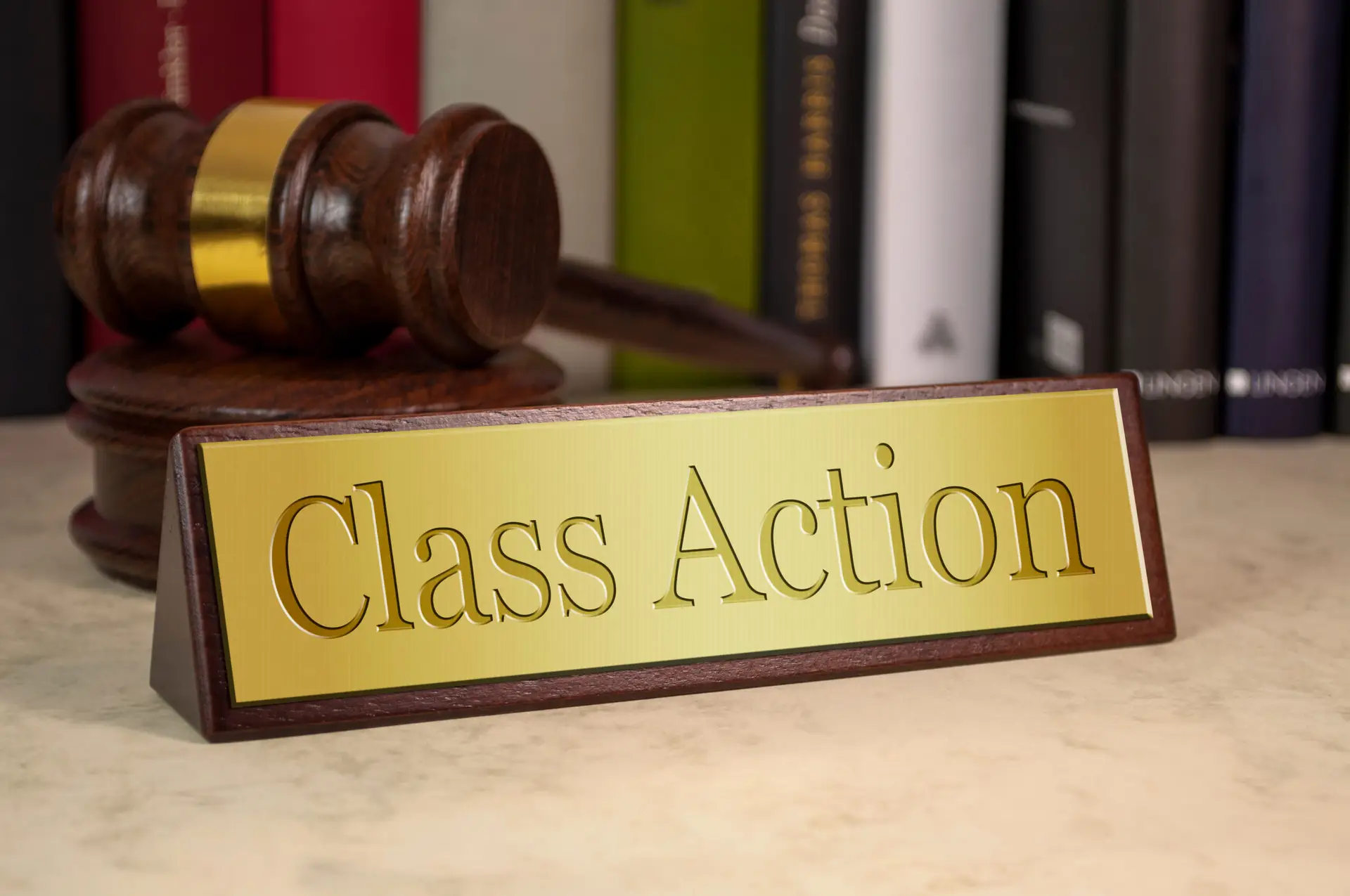 a name plate with the legal term class action sitting on a marble table top