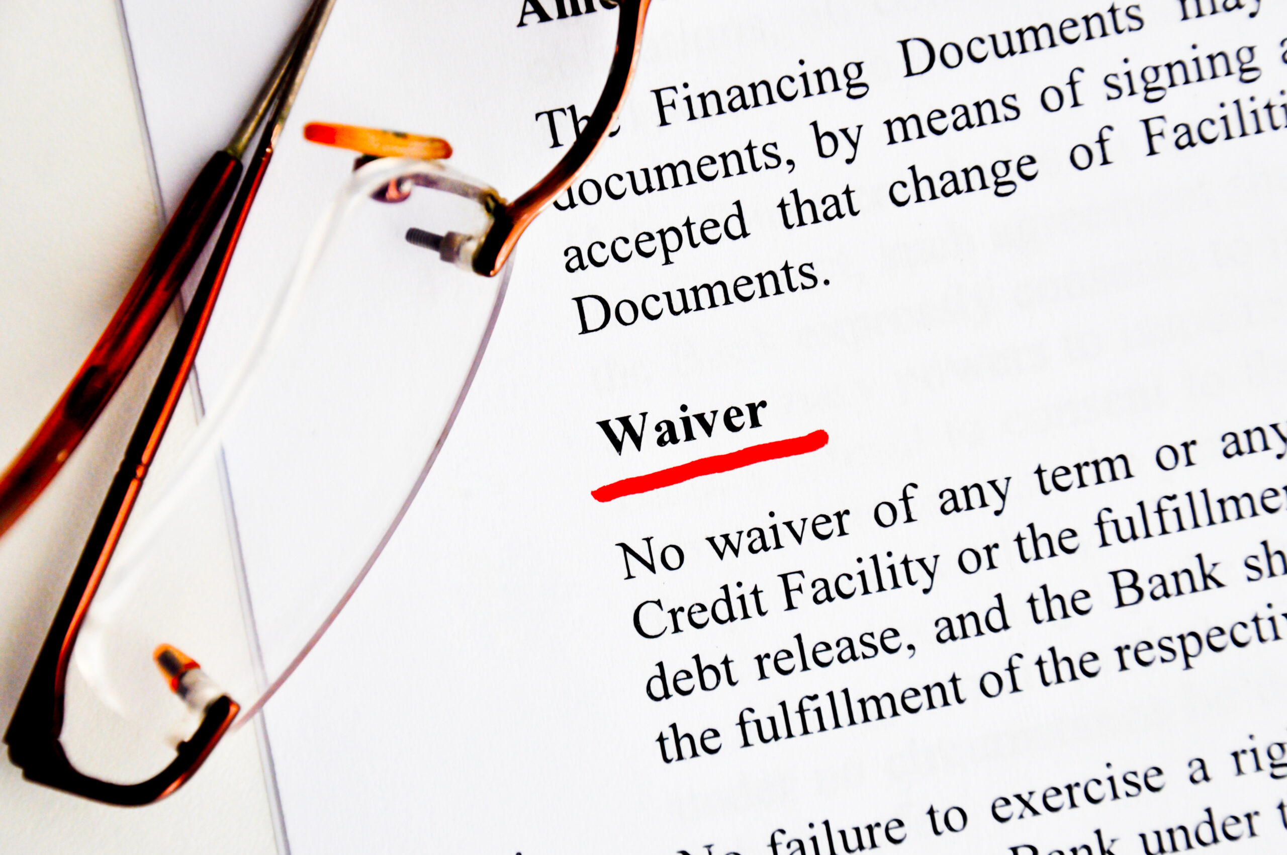 a graphic of a contract with the word waiver underlined in red