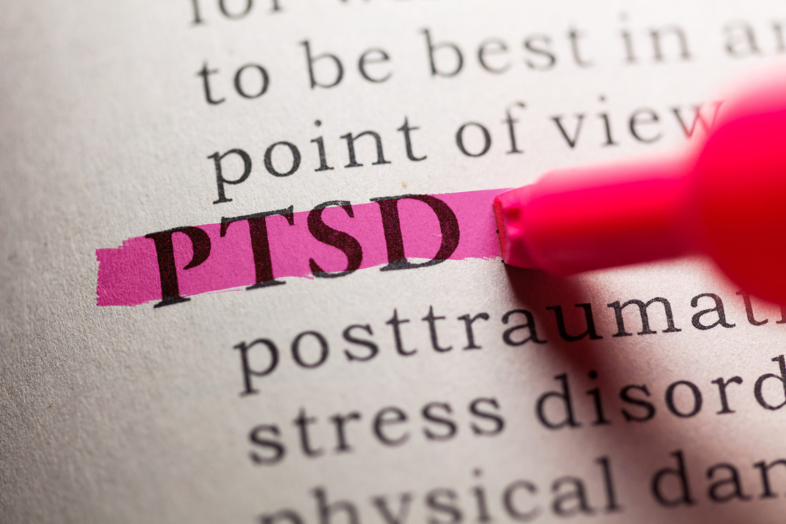 a book with the acronym PTSD highlighted in pink