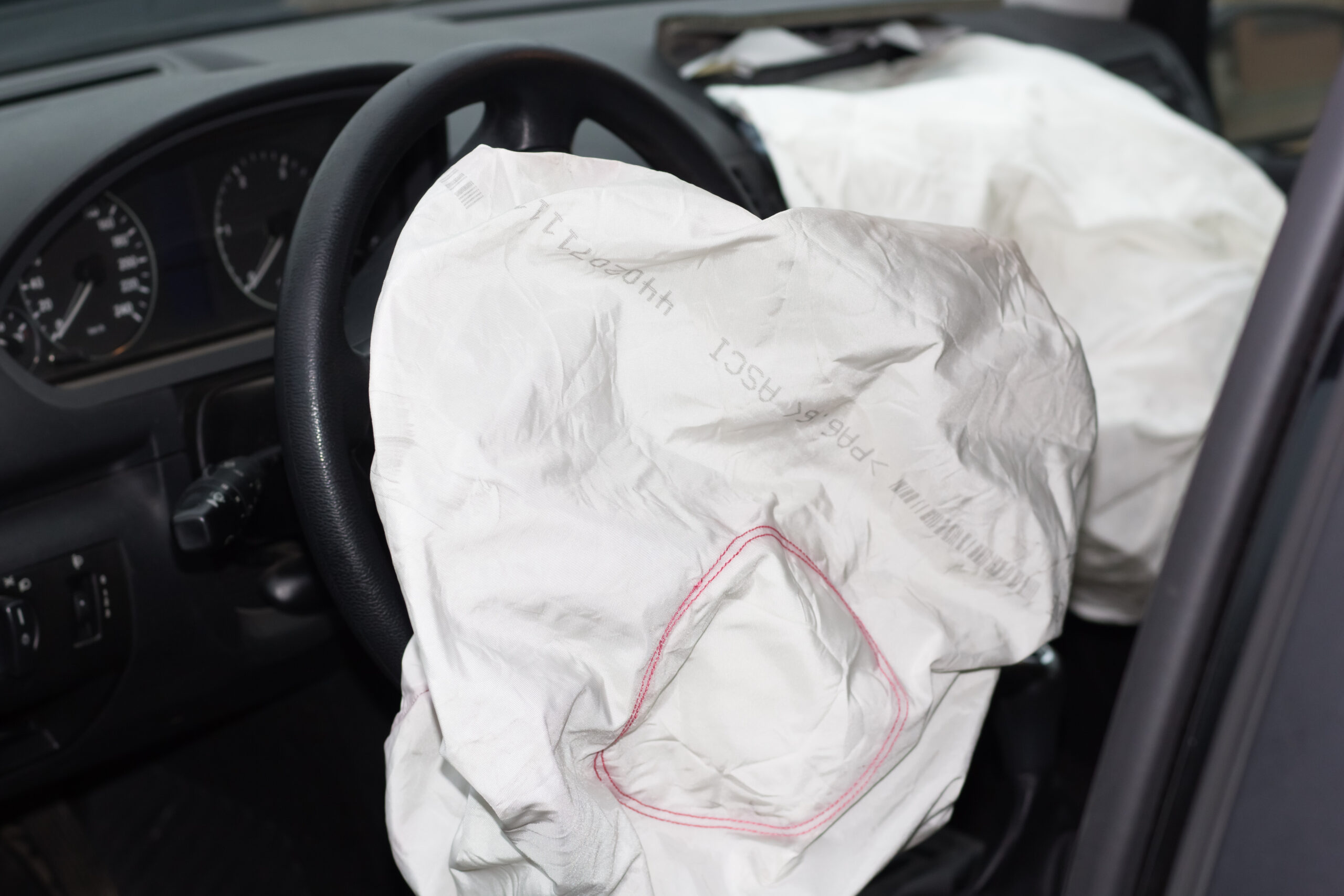 a deployed airbag inside of a car after an accident