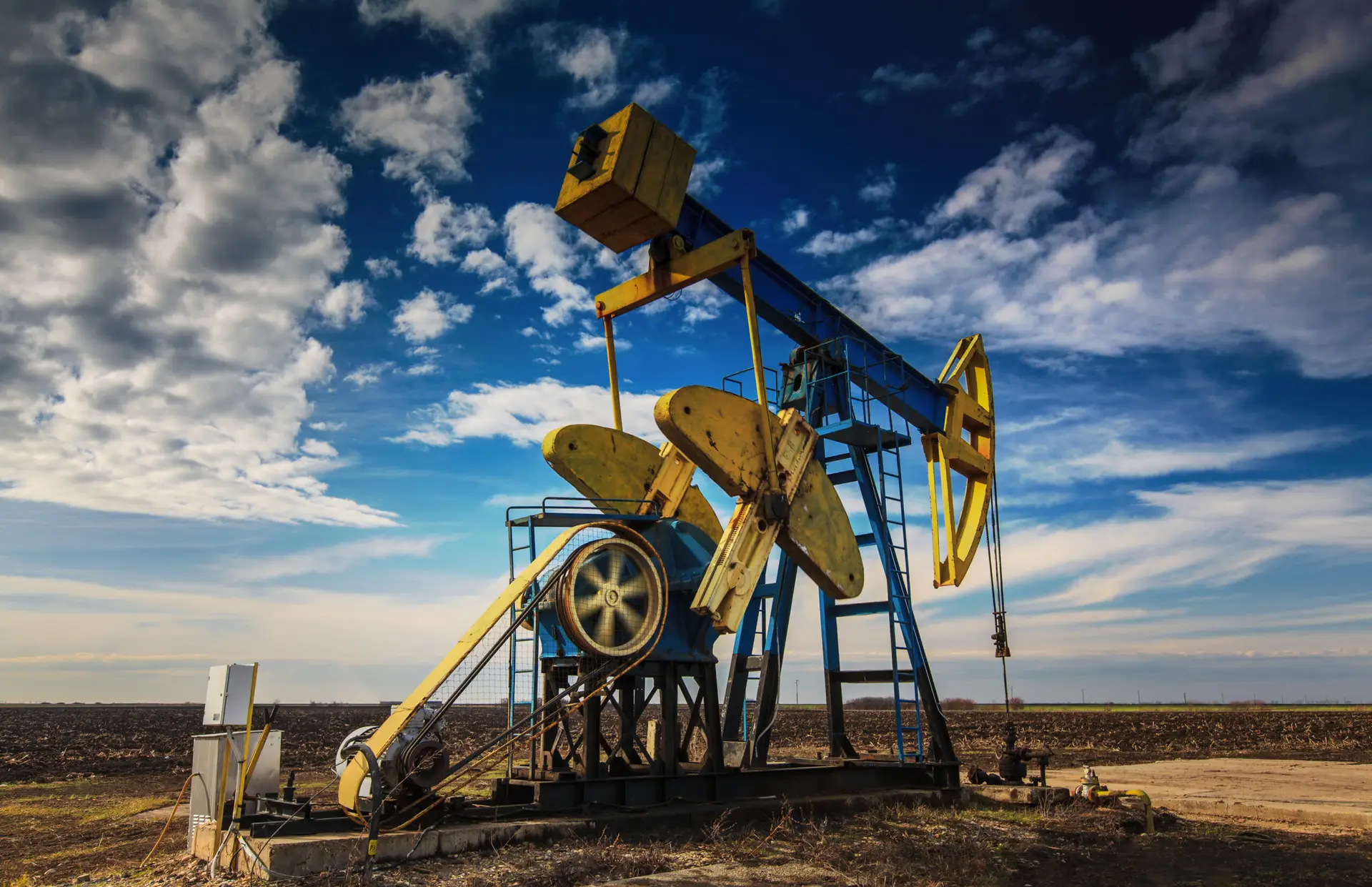 a well head on an open filed symbolizing fracking oil and gas on a property