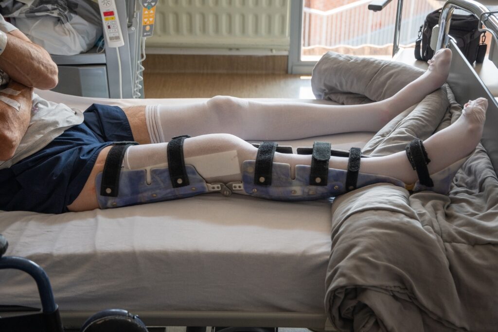 a main in a full leg brace and lower leg cast because of an accident