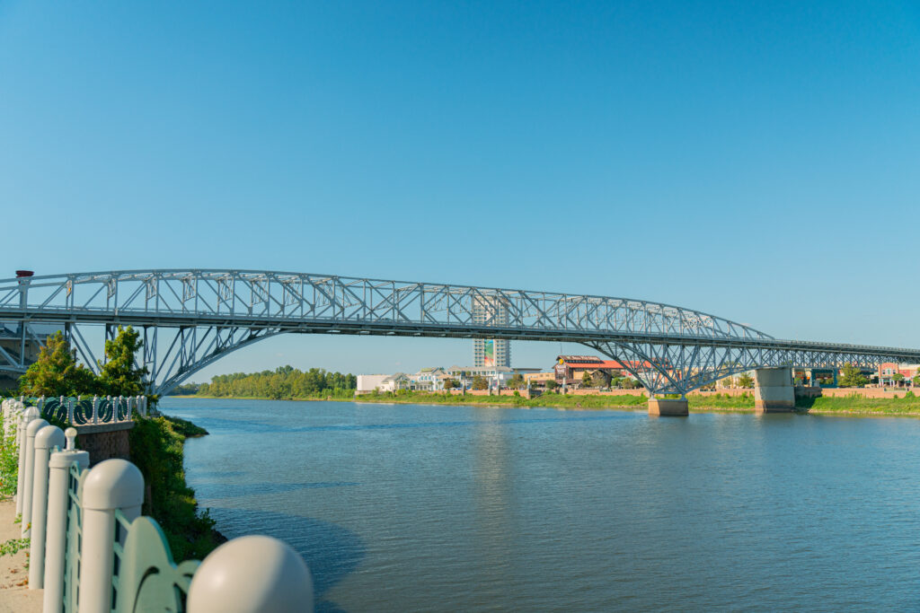 A photo of the red river and texas street bridge from the shore