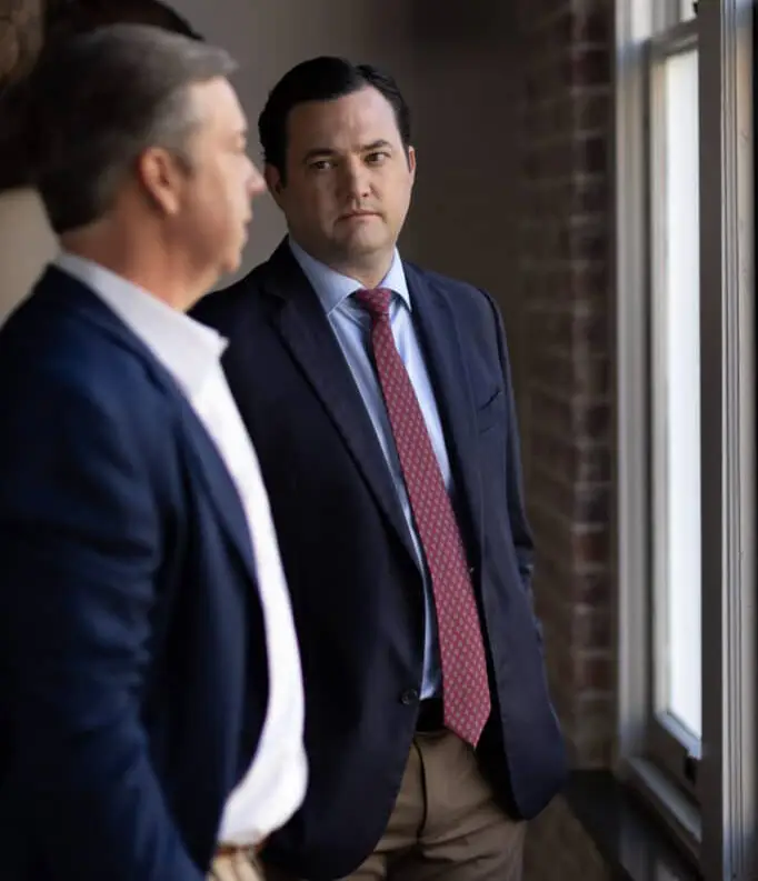 Two lawyers speaking at a window