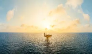 A huge yellow of offshore oil rig drilling platform in the gulf in sunset, Process platform for production oil and gas,Petroleum production and exploration industrial. RC8 Platform