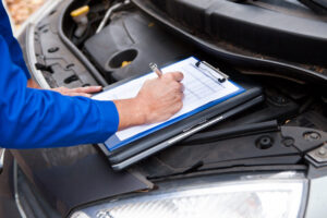 Close-up,of,a,mature,mechanic,maintaining,car,records