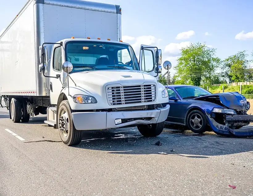 Collision of a semi truck with box trailer a passenger car on the highway road