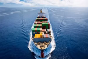 An international waters cargo vessel full of containers at seas representign a jones act vessel