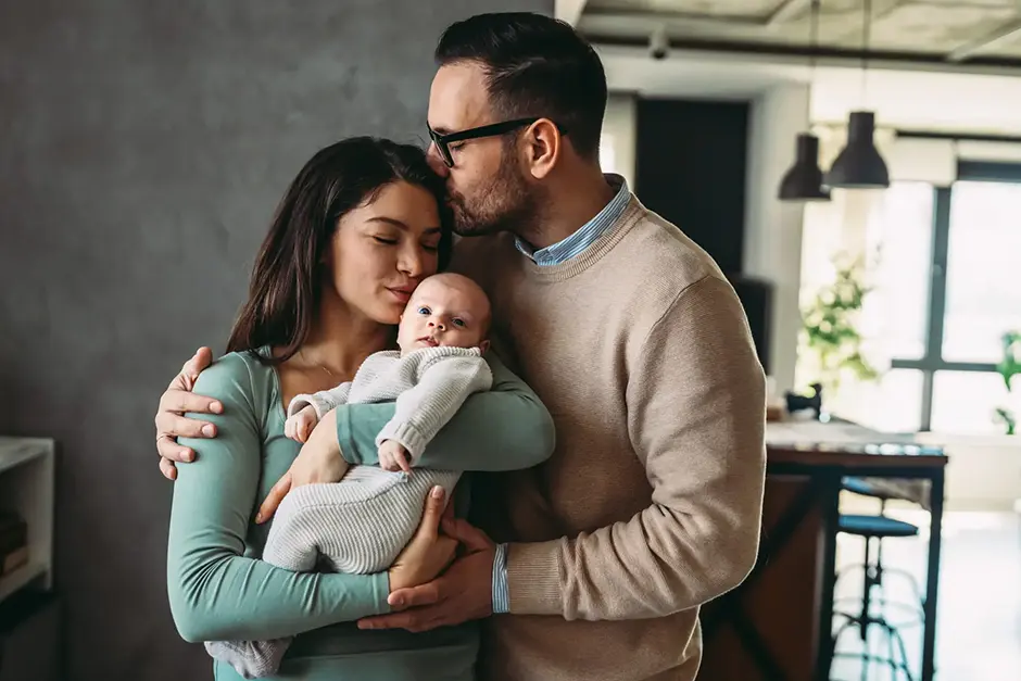 A family of a man, a woman and a baby