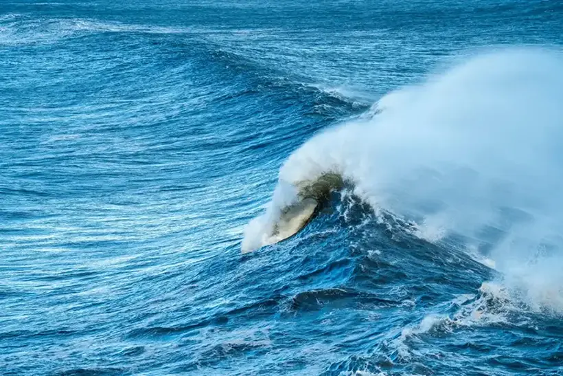 Huge ocean swell and waves lumbering onto the hermanus coastling during a severe winter storm.